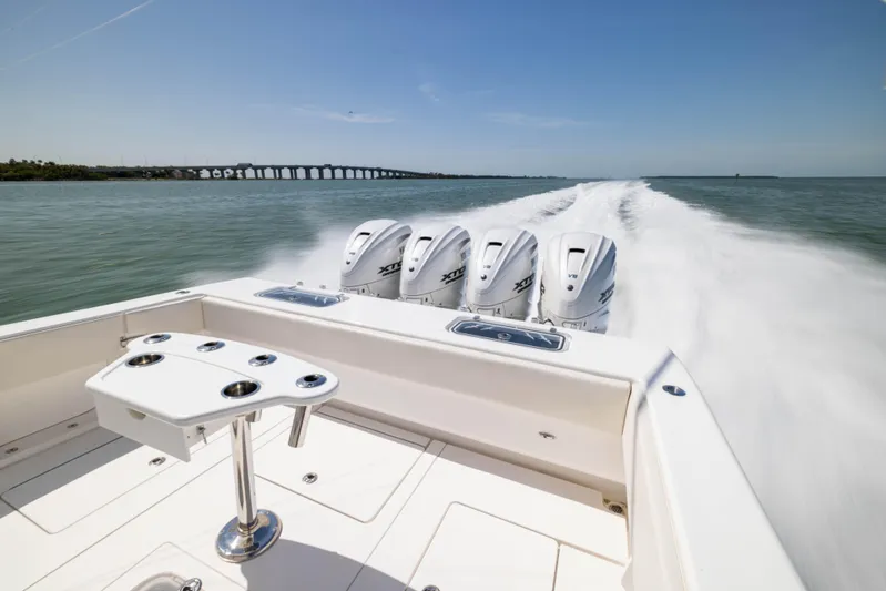 Double Bird Yacht Photos Pics 2020 Contender 44 ST boat speeding on water with four powerful outboard engines.