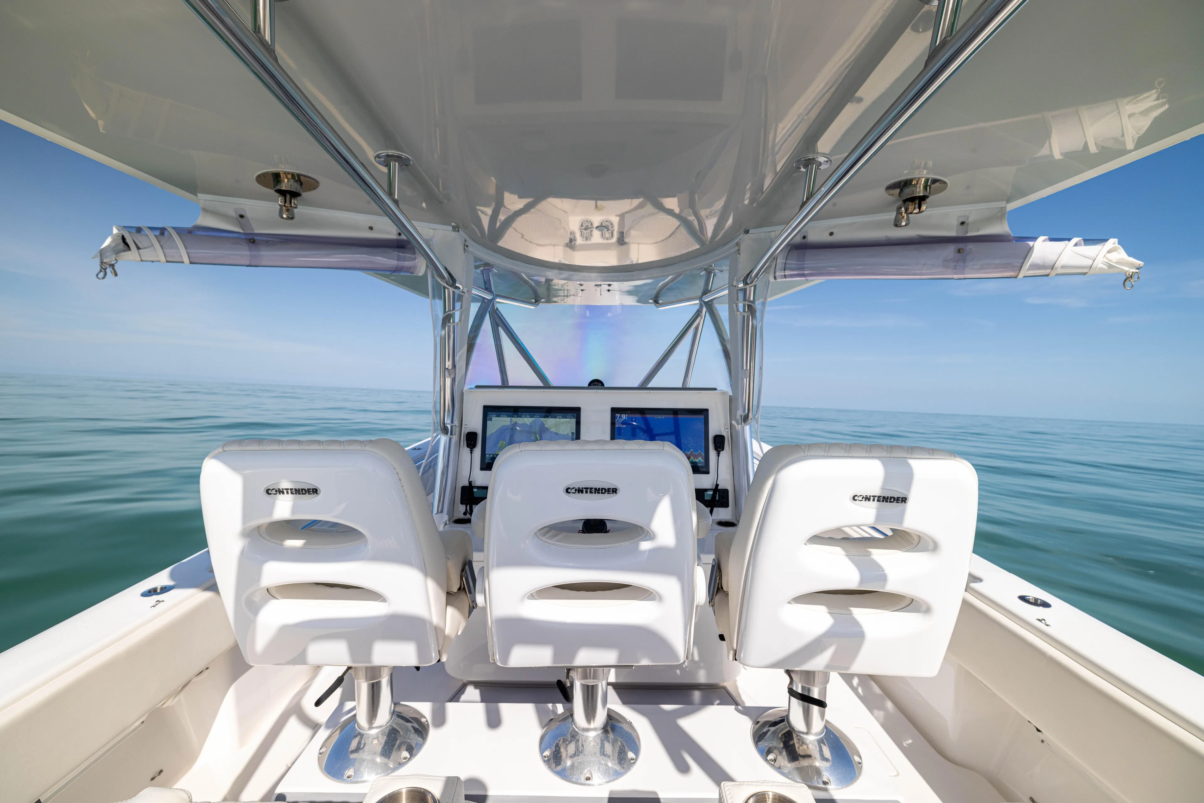 Double Bird Yacht Photos Pics 2020 Contender 44 ST boat interior with three white seats and ocean view.