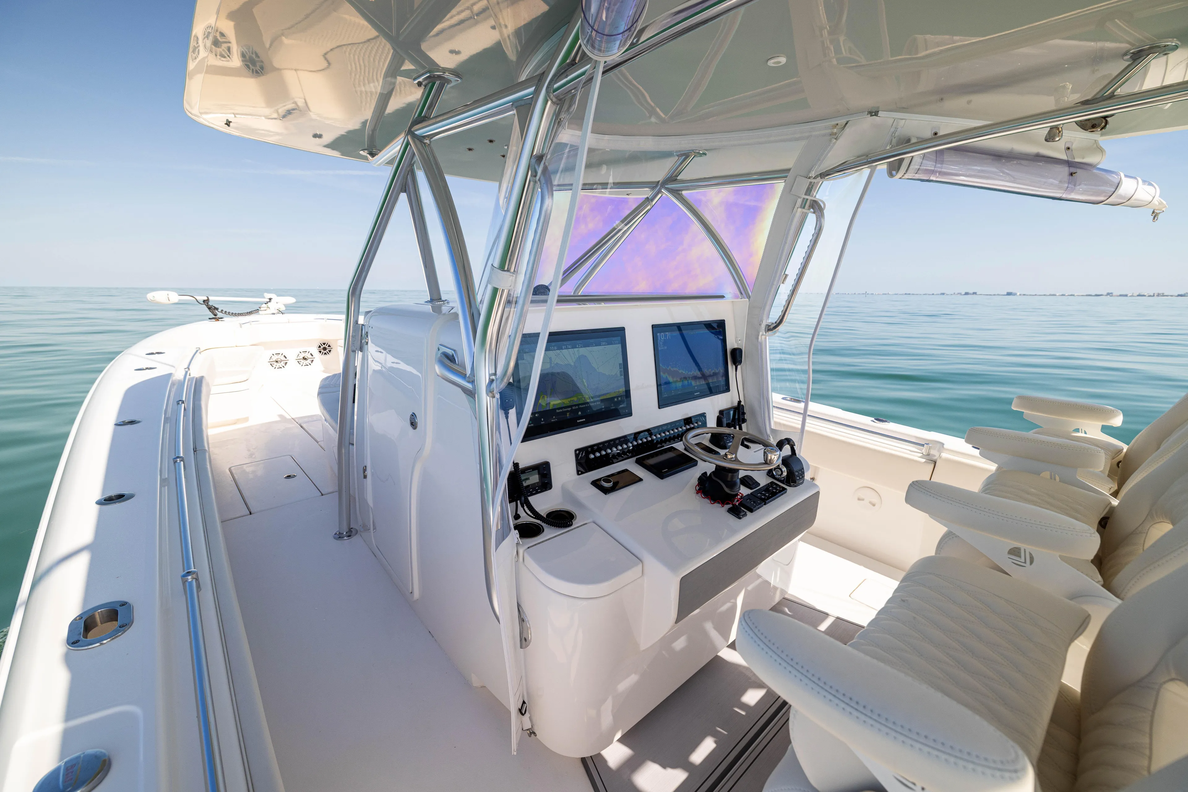 Double Bird Yacht Photos Pics 2020 Contender 44 ST boat interior with modern helm and seating on calm water.