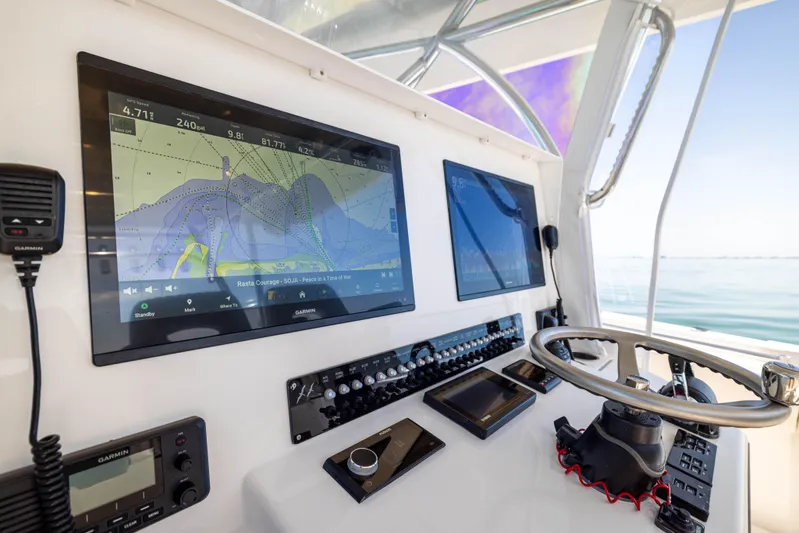 Double Bird Yacht Photos Pics Helm of 2020 Contender 44 ST with navigation screens and steering wheel.
