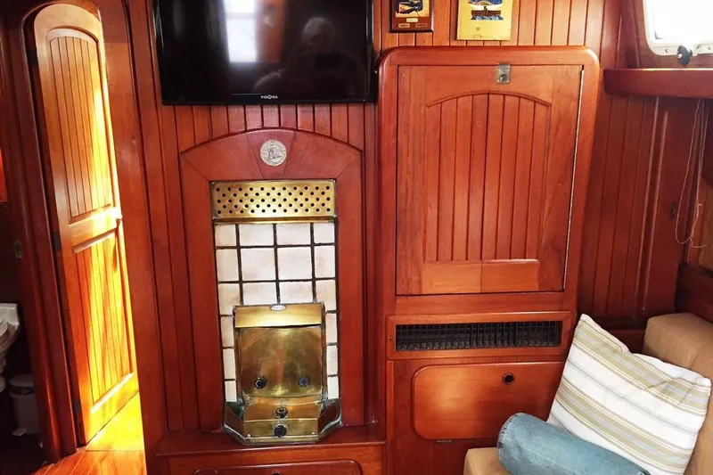 Pacific High Yacht Photos Pics Interior of 1983 Stuart Marine 62 Custom Ketch with wood paneling and brass accents.