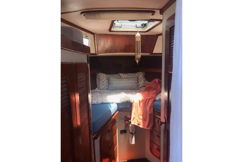 Pacific High Yacht Photos Pics Cozy cabin interior of 1983 Stuart Marine 62 Custom Ketch with wooden accents and skylight.