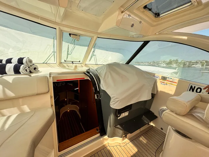 Sassea Yacht Photos Pics Interior of a 2014 Pursuit OS 385 Offshore boat with seating and cabin entrance.