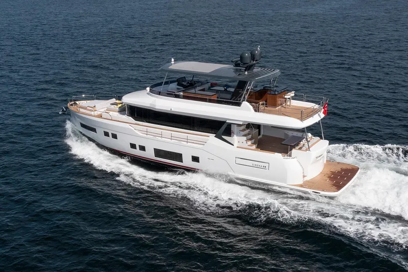  Yacht Photos Pics Luxurious 2027 Sirena 68 yacht cruising on open water, showcasing sleek design and elegance.
