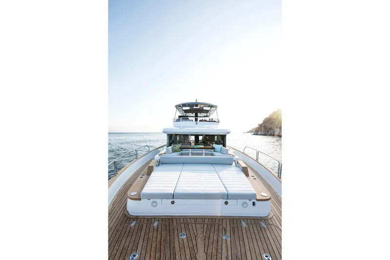  Yacht Photos Pics Luxurious 2027 Sirena 68 yacht with spacious deck and sunbed, cruising on serene waters.