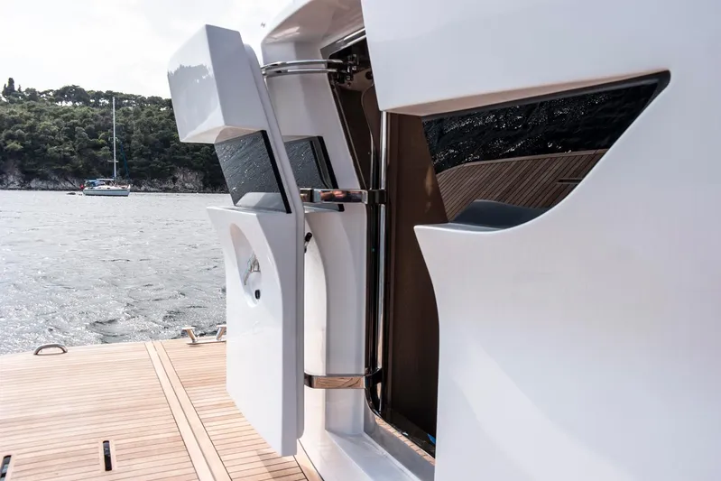  Yacht Photos Pics Sleek design of 2027 Sirena 68 yacht door, open to scenic waters.