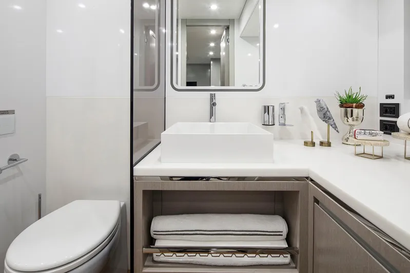  Yacht Photos Pics Modern bathroom on Sirena 68 yacht, featuring sleek sink, mirror, and elegant decor, 2027 model.