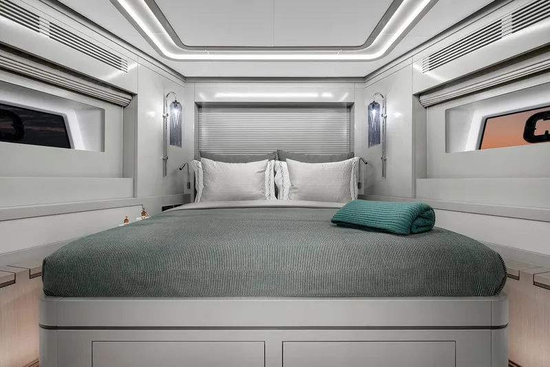  Yacht Photos Pics Luxurious bedroom interior of 2027 Sirena 68 yacht, featuring modern design and elegant bedding.