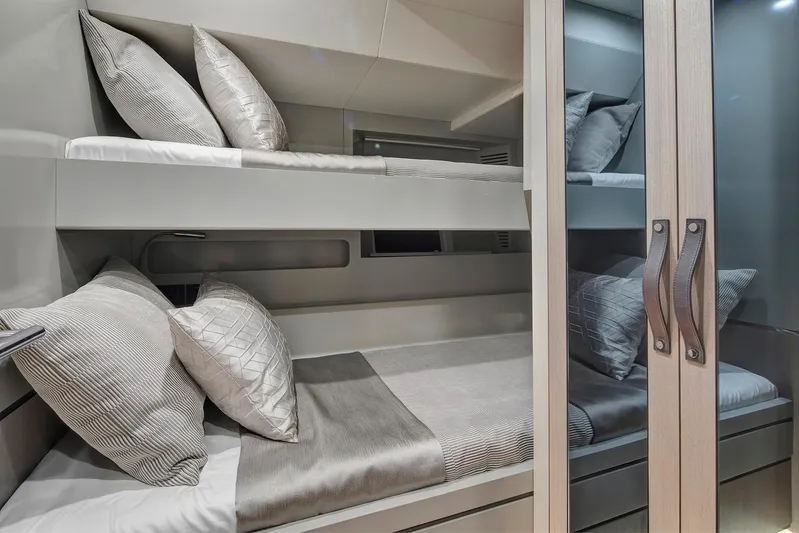  Yacht Photos Pics Luxurious bunk beds in the 2027 Sirena 68 yacht cabin, featuring elegant bedding and modern design.