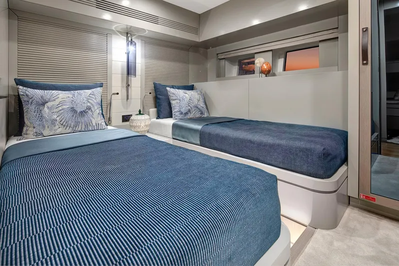  Yacht Photos Pics Luxurious twin bedroom in 2027 Sirena 68 yacht with elegant blue decor.
