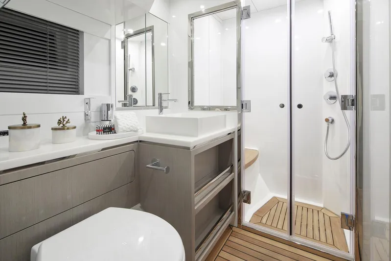  Yacht Photos Pics Modern bathroom in 2027 Sirena 68 yacht with sleek fixtures and glass shower.