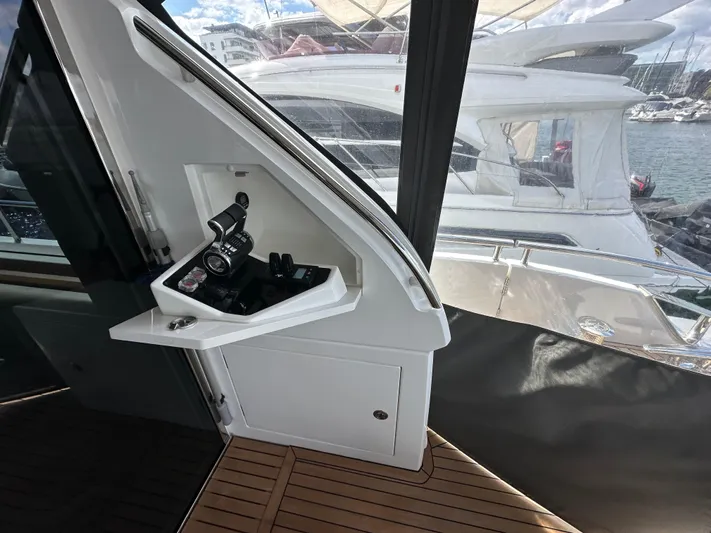  Yacht Photos Pics Interior view of 2022 Princess Y72 yacht with control panel and wooden flooring.