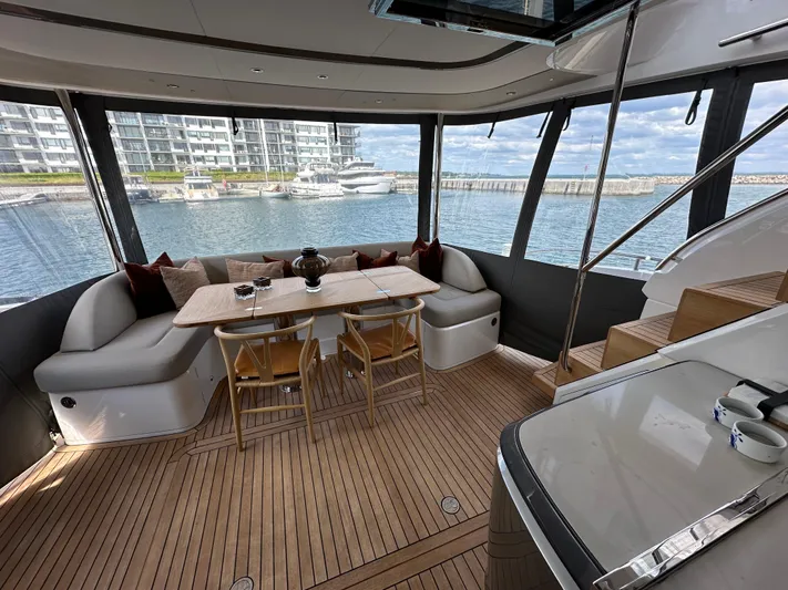  Yacht Photos Pics Luxurious 2022 Princess Y72 yacht interior with elegant dining area and scenic marina view.