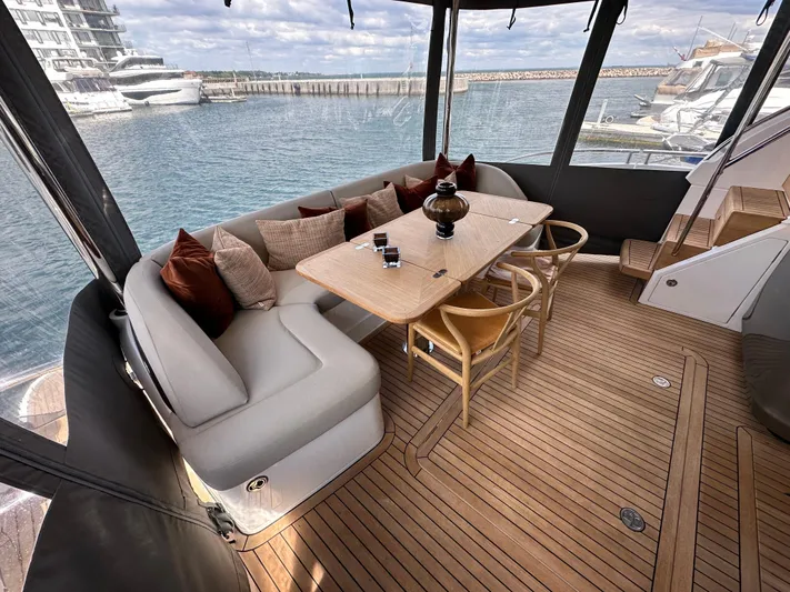  Yacht Photos Pics Luxurious 2022 Princess Y72 yacht interior with elegant seating and dining area, overlooking marina.