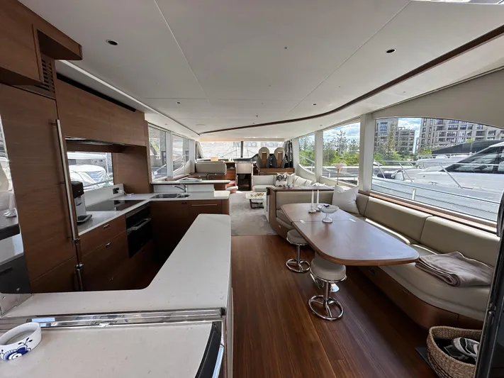  Yacht Photos Pics Luxurious interior of 2022 Princess Y72 yacht with modern kitchen and seating area.