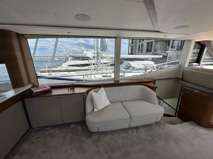  Yacht Photos Pics Luxurious interior of 2022 Princess Y72 yacht with marina view through large windows.
