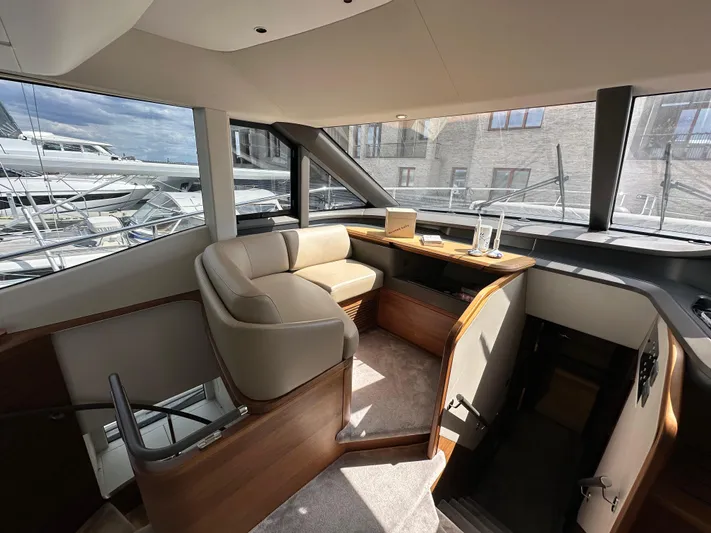  Yacht Photos Pics Luxurious interior of 2022 Princess Y72 yacht with elegant seating and panoramic windows.