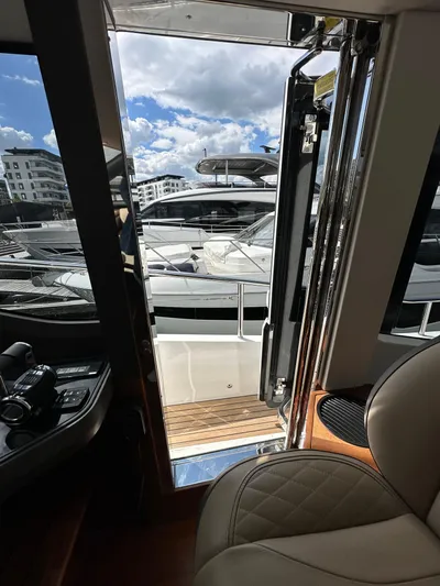  Yacht Photos Pics Interior view of 2022 Princess Y72 yacht with marina in the background.