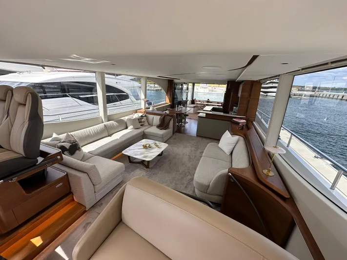  Yacht Photos Pics Luxurious interior of 2022 Princess Y72 yacht with elegant seating and panoramic windows.
