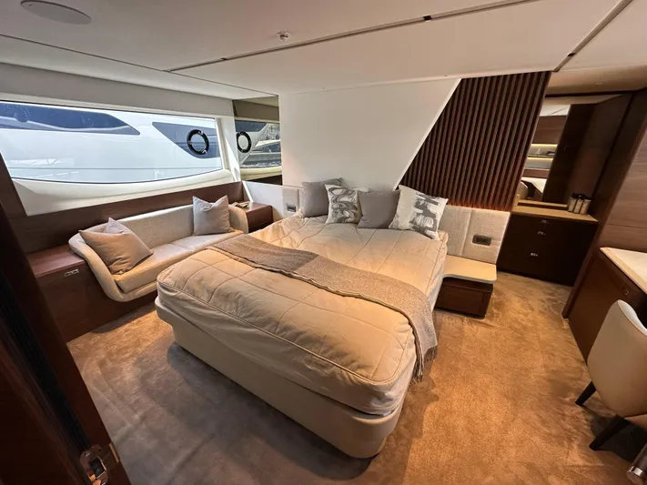  Yacht Photos Pics Luxurious bedroom interior of 2022 Princess Y72 yacht with elegant furnishings and large windows.