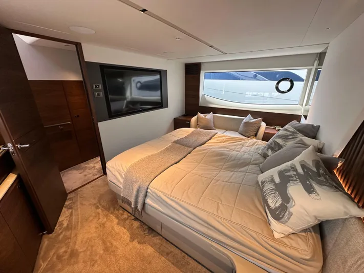  Yacht Photos Pics Luxurious bedroom interior of 2022 Princess Y72 yacht with modern decor and large window view.