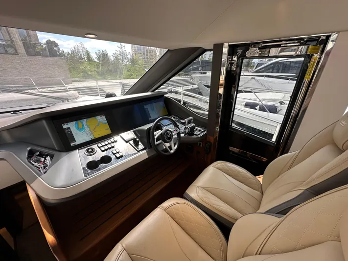  Yacht Photos Pics Luxurious 2022 Princess Y72 yacht cockpit with modern navigation system and plush seating.