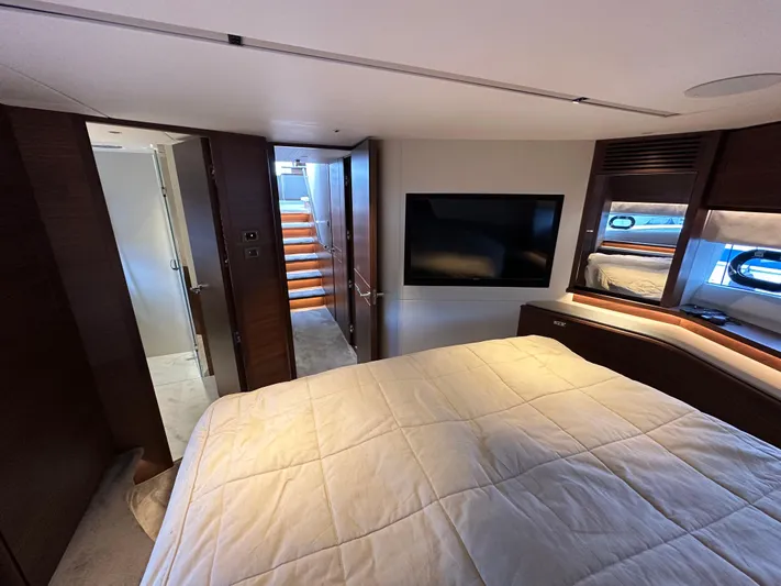  Yacht Photos Pics Luxurious bedroom interior of 2022 Princess Y72 yacht with modern design and cozy ambiance.