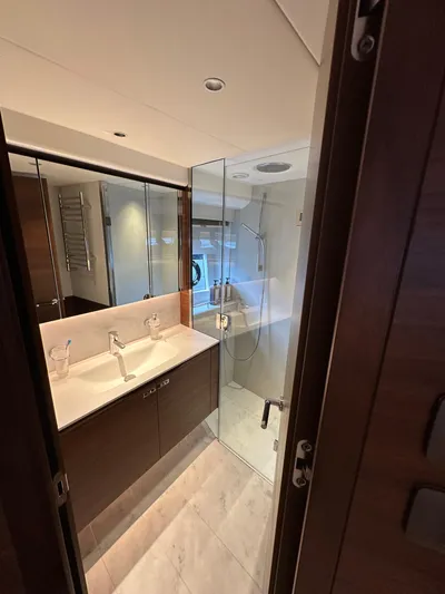  Yacht Photos Pics Luxurious bathroom in 2022 Princess Y72 yacht with modern fixtures and glass shower.