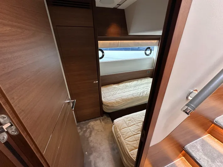 Yacht Photos Pics Luxurious cabin interior of 2022 Princess Y72 yacht with twin beds and wooden finish.