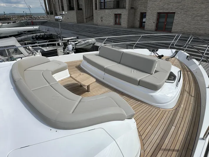  Yacht Photos Pics Luxurious 2022 Princess Y72 yacht deck with elegant seating and wooden flooring.