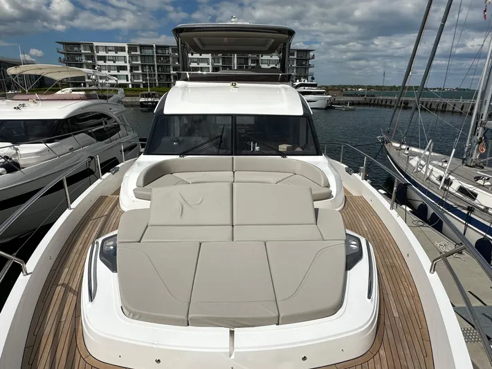  Yacht Photos Pics Luxury 2022 Princess Y72 yacht with spacious deck, docked at marina under cloudy sky.