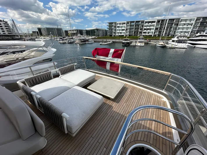  Yacht Photos Pics Luxury Princess Y72 yacht deck with sun loungers, marina view, and Danish flag, 2022 model.