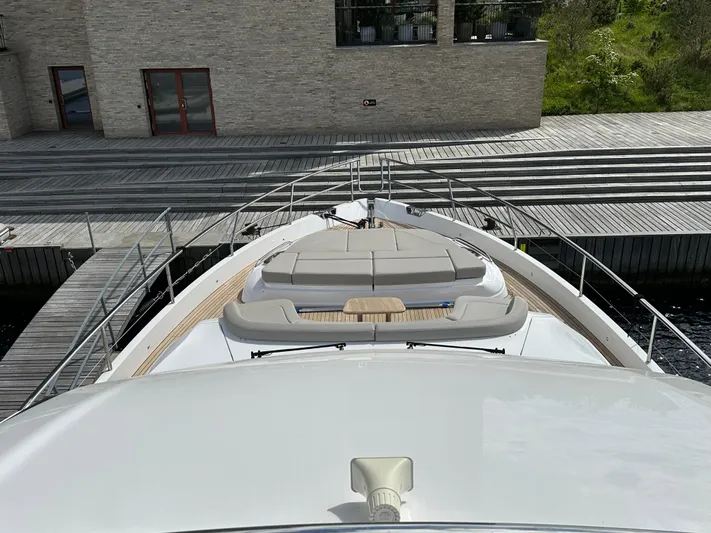  Yacht Photos Pics Luxury Princess Y72 yacht bow view, 2022 model, docked near modern building.