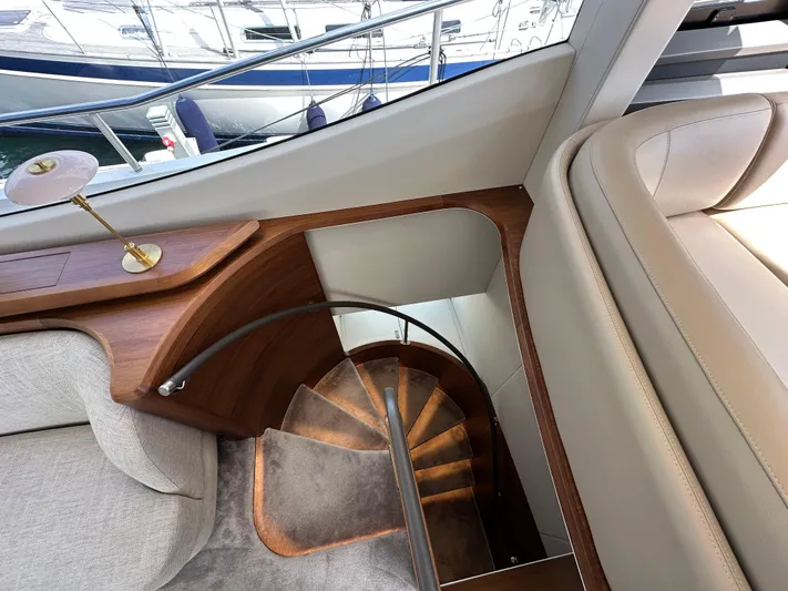  Yacht Photos Pics Luxurious interior of 2022 Princess Y72 yacht with elegant wooden staircase.