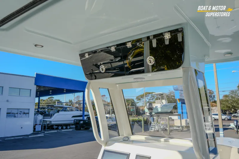  Yacht Photos Pics 2026 Key West 260 Center Console boat interior at dealership, featuring storage compartment.