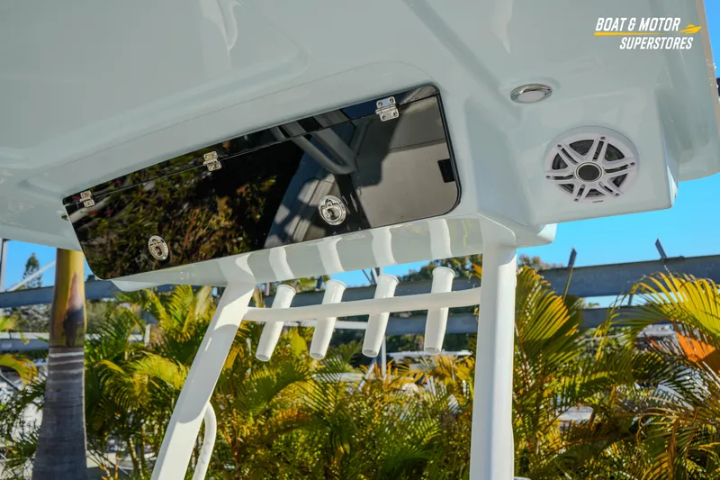  Yacht Photos Pics 2026 Key West 260 Center Console boat with rod holders and speaker, surrounded by tropical foliage.