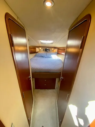  Yacht Photos Pics 2007 Sea Ray 44 Sundancer cabin interior with bed and wooden doors.