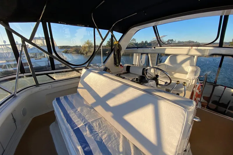 Irish Hurricane Yacht Photos Pics 1998 Carver 445 Aft Cabin Motor Yacht interior with helm, seating, and scenic water view.