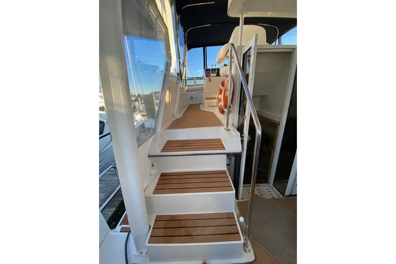 Irish Hurricane Yacht Photos Pics Staircase on 1998 Carver 445 Aft Cabin Motor Yacht with wooden steps and railing.