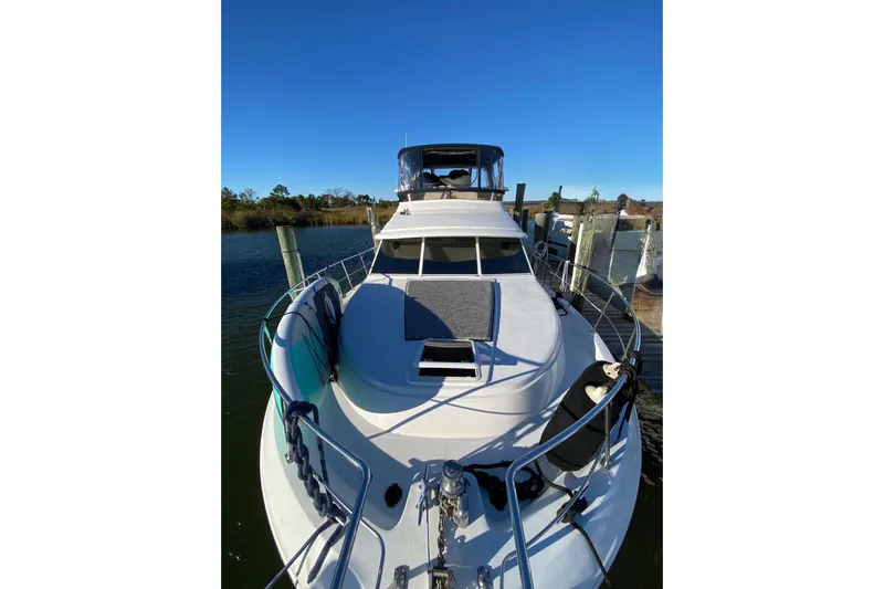 Irish Hurricane Yacht Photos Pics 1998 Carver 445 Aft Cabin Motor Yacht docked, showcasing sleek design and spacious deck.