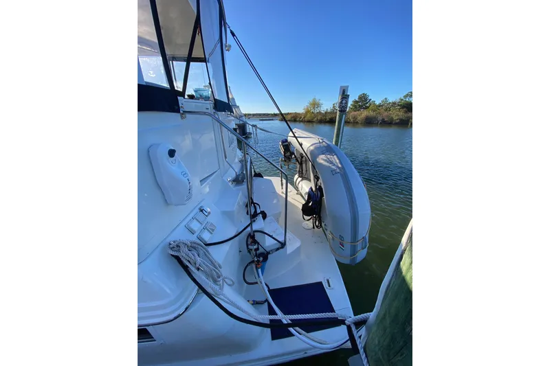 Irish Hurricane Yacht Photos Pics 1998 Carver 445 Aft Cabin Motor Yacht docked, featuring a dinghy and clear blue sky.