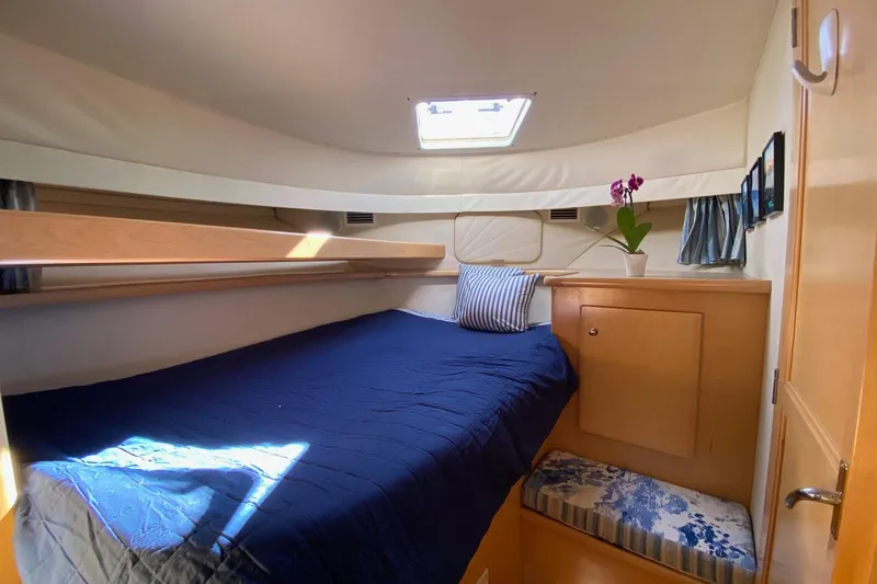 Irish Hurricane Yacht Photos Pics Cozy cabin interior of 1998 Carver 445 Aft Cabin Motor Yacht with bed and porthole.