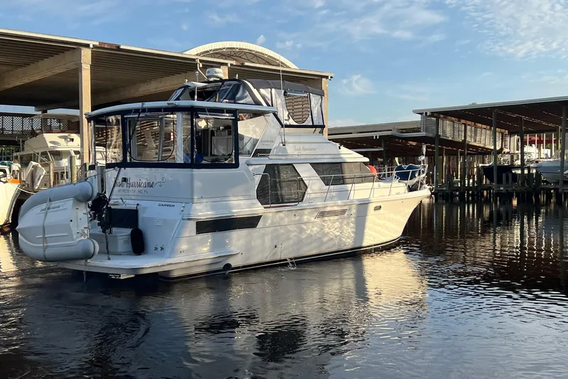 Irish Hurricane Yacht Photos Pics 1998 Carver 445 Aft Cabin Motor Yacht docked at marina under clear sky.