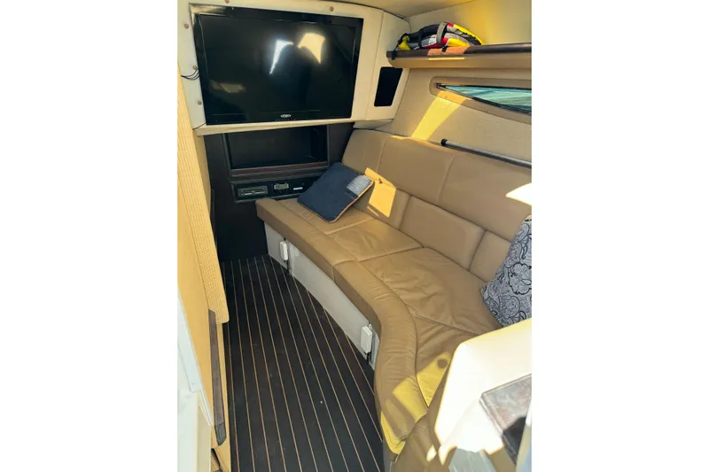  Yacht Photos Pics 2013 Cobalt 336 cabin interior with leather seating, TV, and striped flooring.