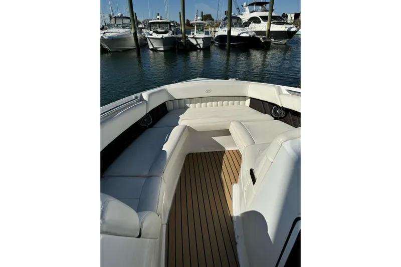  Yacht Photos Pics 2013 Cobalt 336 boat interior with white seating and wooden deck, docked at marina.
