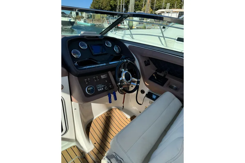  Yacht Photos Pics Interior view of 2013 Cobalt 336 boat cockpit with steering wheel and dashboard controls.