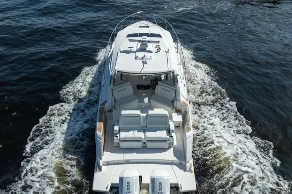  Yacht Photos Pics 2022 Tiara Sport 43 LE luxury boat cruising on open water.