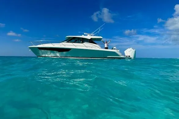  Yacht Photos Pics 2022 Tiara Sport 43 LE yacht cruising on clear blue ocean waters.