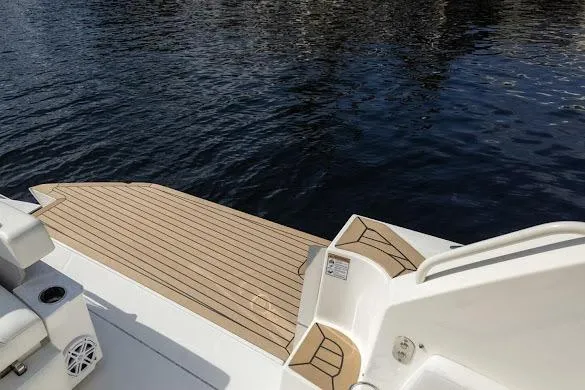  Yacht Photos Pics 2022 Tiara Sport 43 LE boat with teak deck by the water.