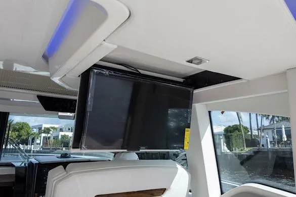  Yacht Photos Pics 2022 Tiara Sport 43 LE interior with mounted TV and modern seating.